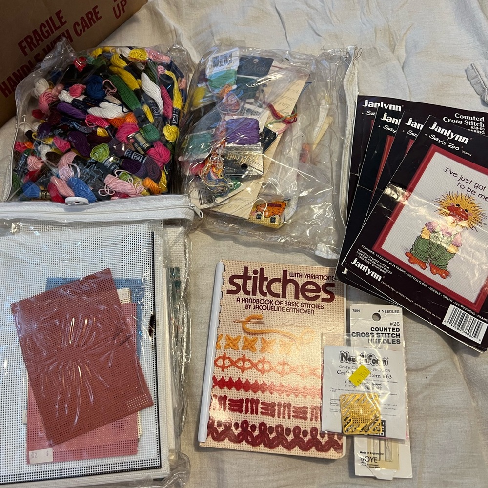 Assorted vintage cross-stitch embroidery supplies